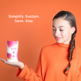 Teenage model holding the Saalt Teen menstrual cup.